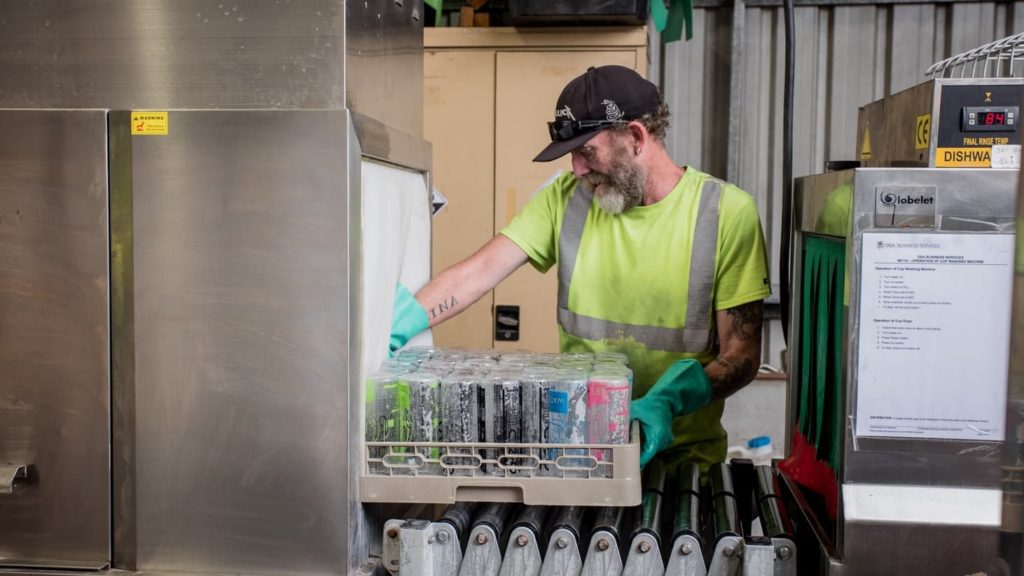 man recycling bottles